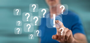 person pointing to question marks