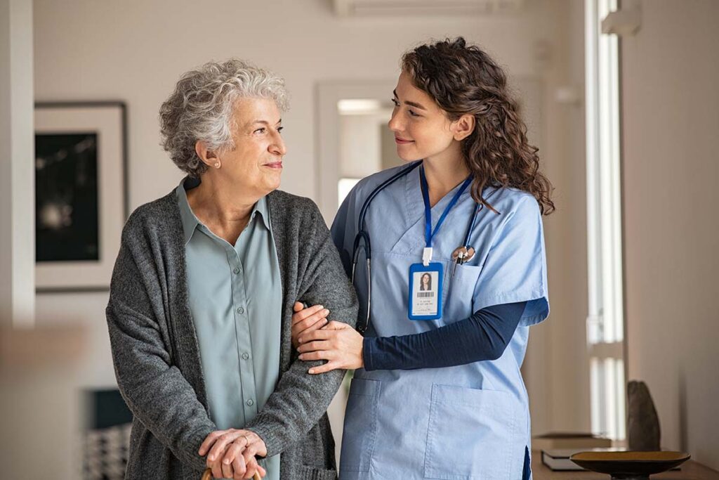 Health care worker holding onto a patient's arm