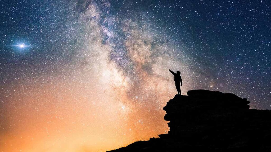 Person reach towards the stars