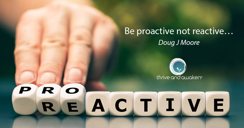 A hand pushing some tiles over to spell Proactive rather than Reactive