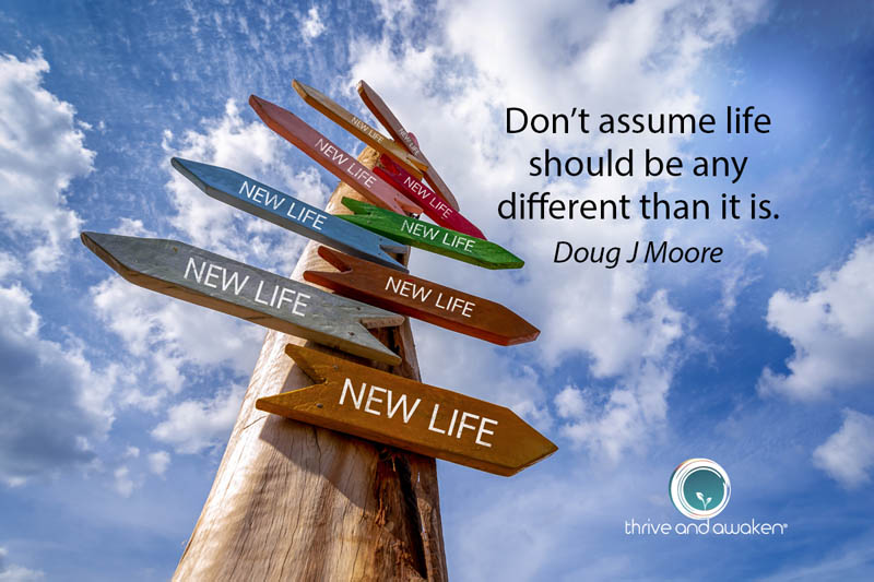 Cross roads sign with quote from Doug: Don't assume life should be any different than it is