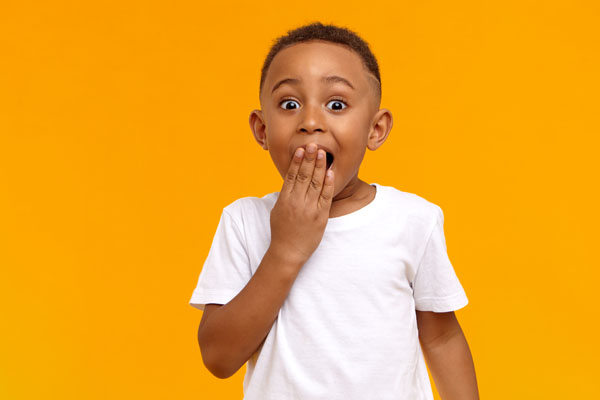 Little boy with hand to its mouth