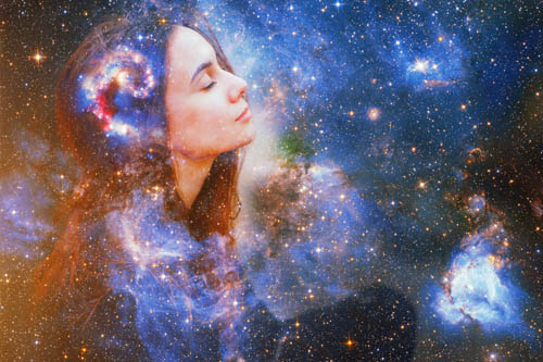 Womans face emerging from the cosmos