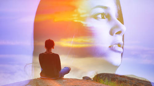 Woman meditating and visioning herself as part of the sky