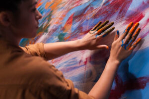 person painting with their hands