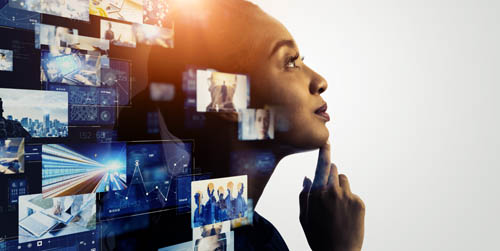Woman gazing in thought with images of screens inside and outside of her head